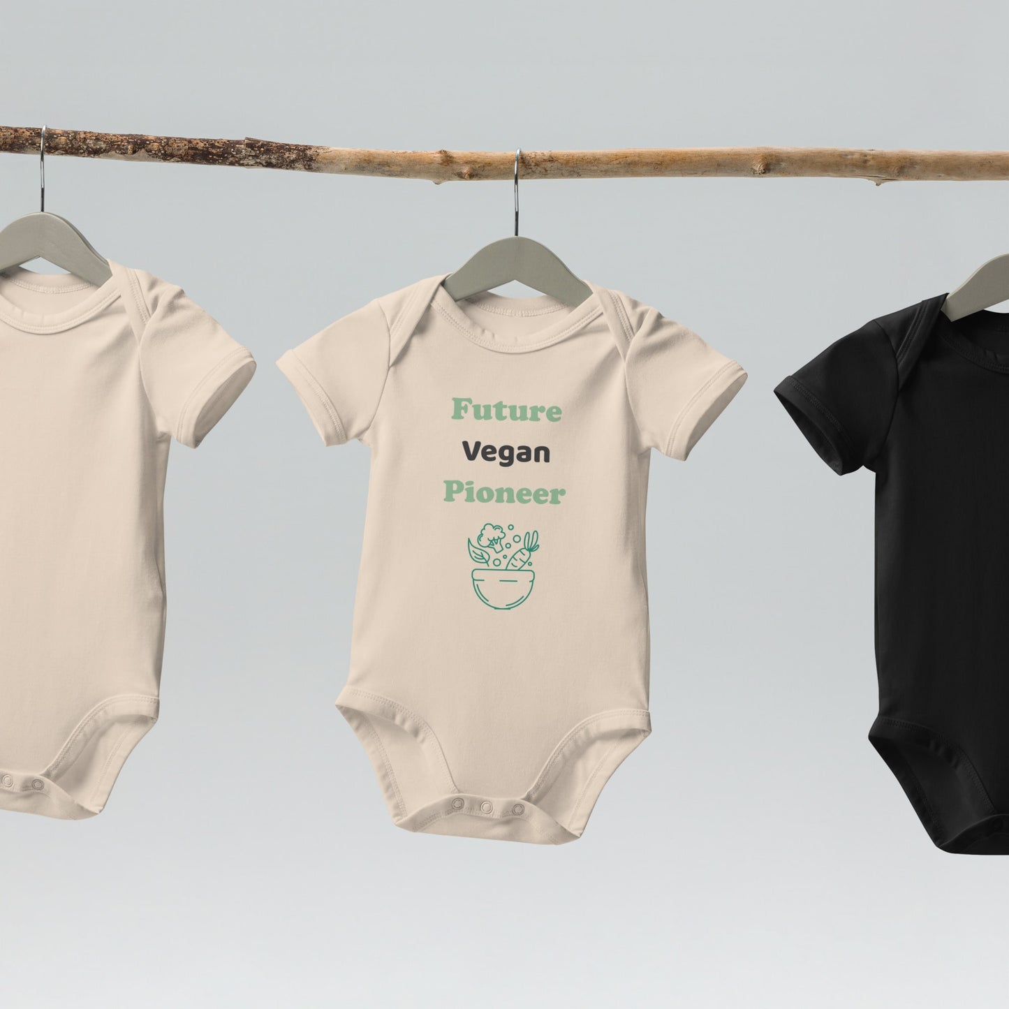 A natural-colored organic cotton baby bodysuit hanging on a wooden hanger, highlighting its eco-friendly and unbleached fabric.