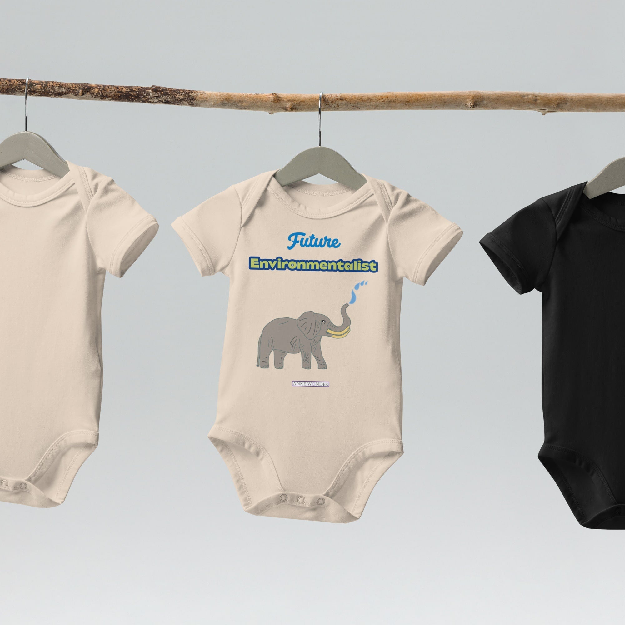 Natural bodysuits displayed on a  hanger with elephant graphic and the words 'Future Environmentalist' by Anke Wonder.