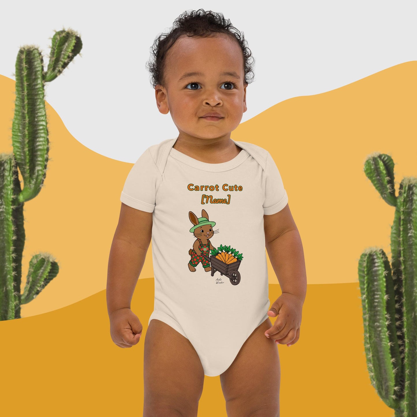 Child wearing a onesie with a cartoon bunny and carrot cute text, standing against a desert landscape with cacti.