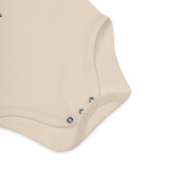 Snap closure detail on an organic cotton baby bodysuit for quick and easy diaper changes.