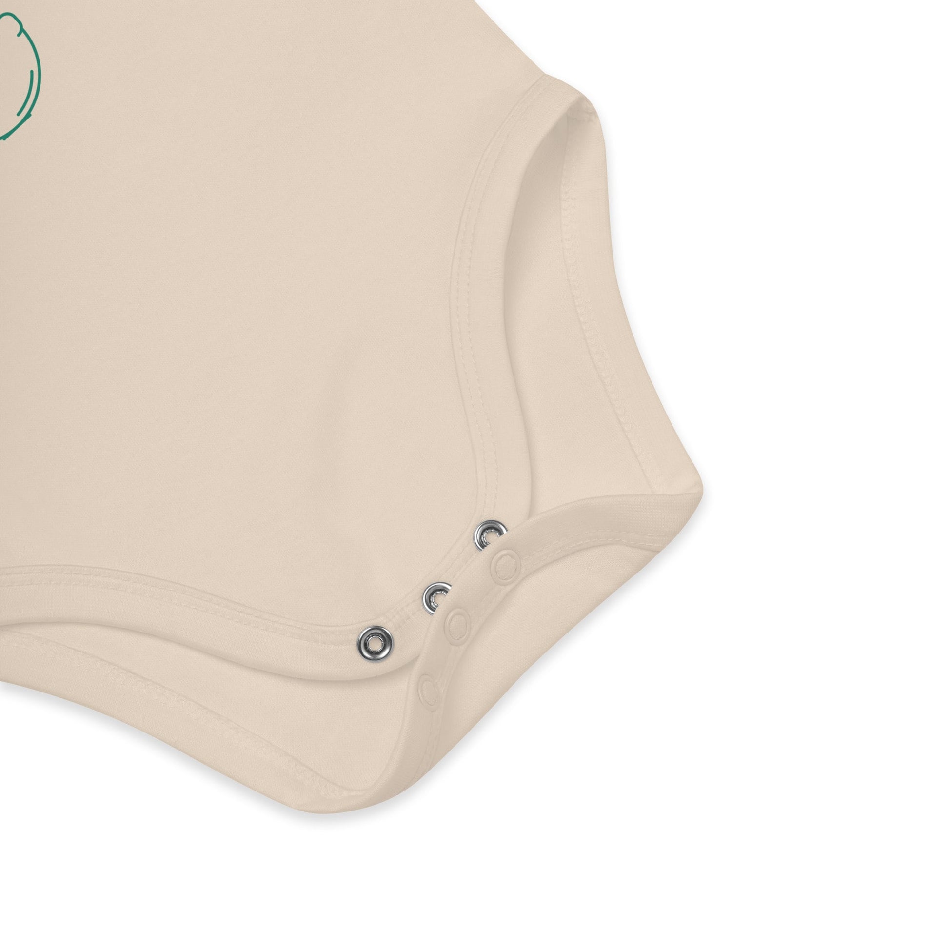 A detailed close-up of the snap fasteners on a natural-colored organic cotton baby bodysuit, emphasizing its durability and eco-conscious design.