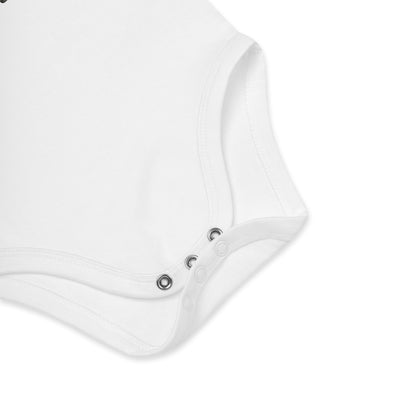 Close-up of poppers at crotch of a white short-sleeve organic cotton baby bodysuit by Anke Wonder.