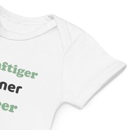 A detailed close-up of the sleeve of a white organic cotton baby bodysuit, showing its high-quality stitching and softness.