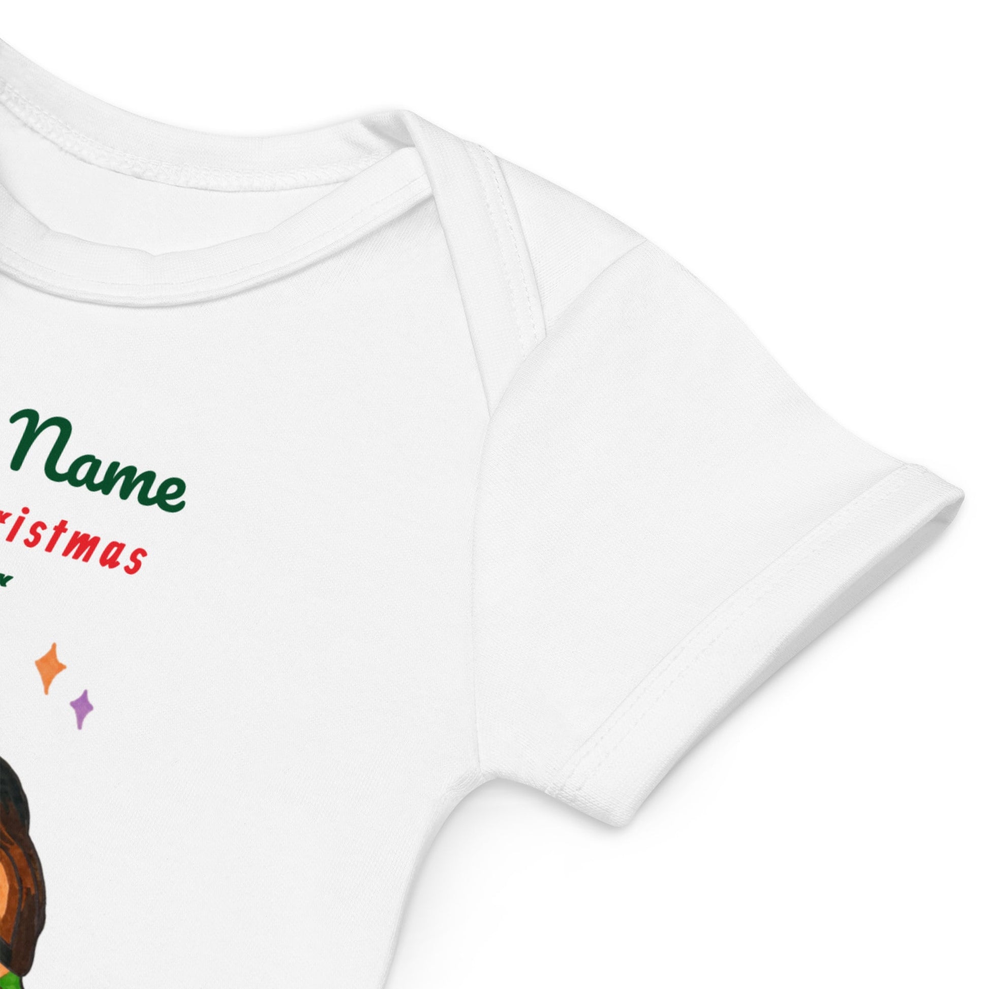 Sleeve detail of a white baby onesie with colorful text and Christmas graphics on a white background