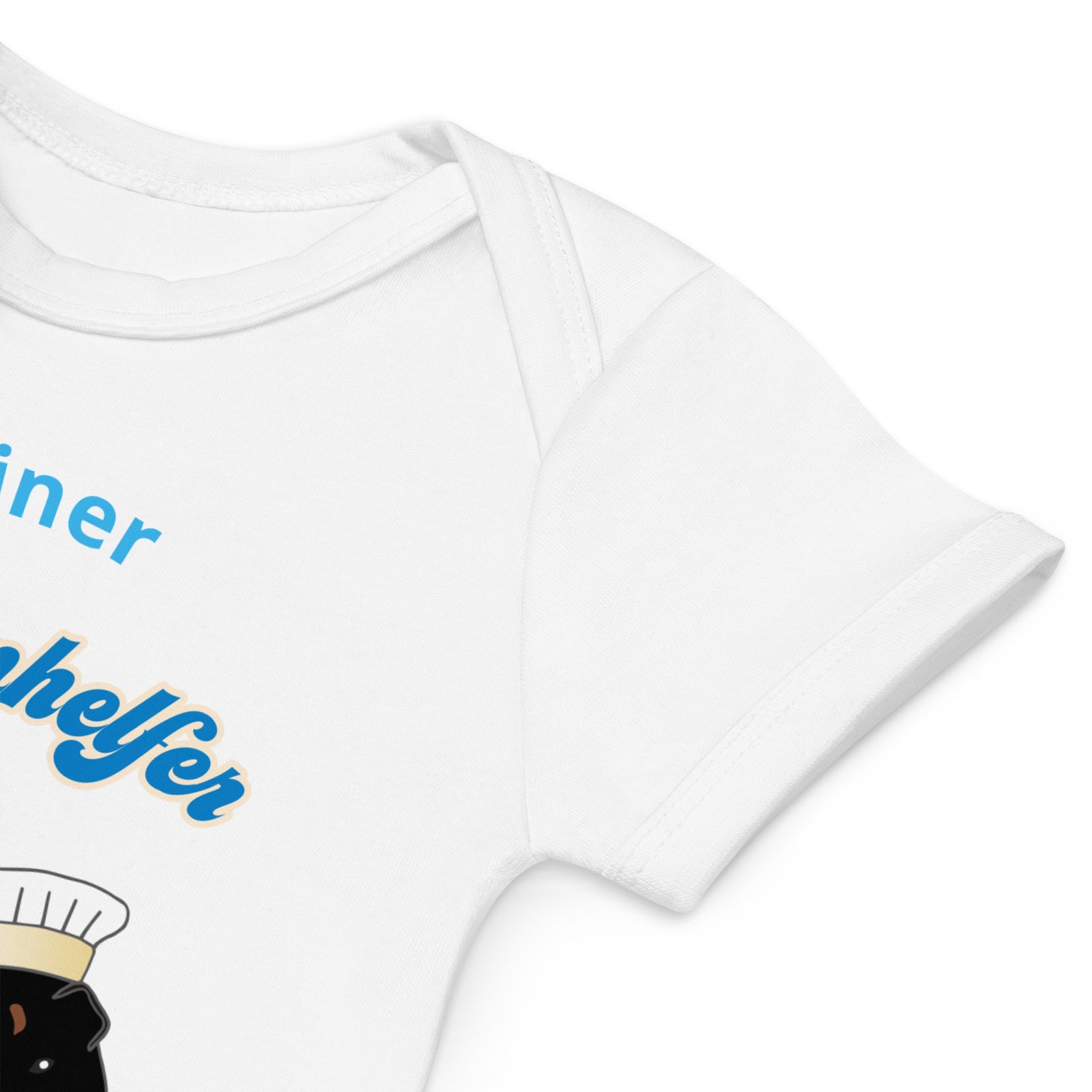 White organic cotton baby bodysuit sleeve close-up, showcasing fabric texture and partially the guinea pig design with blue text.