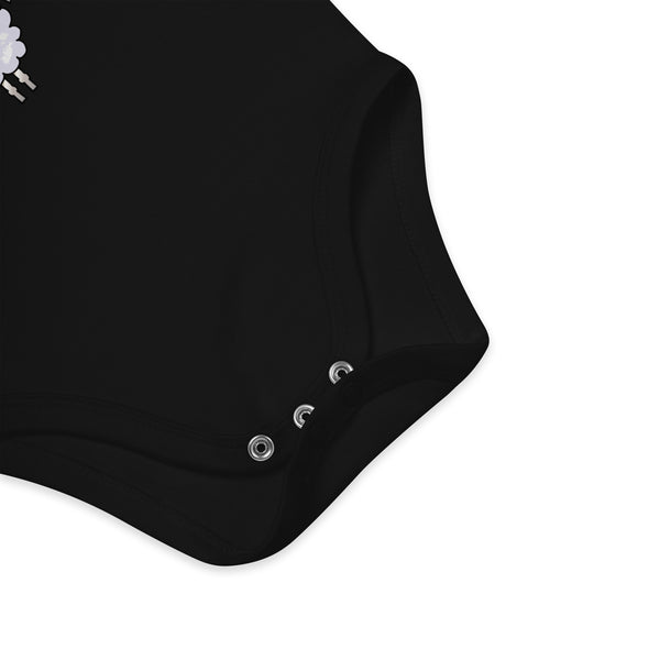 Snap closure detail on an organic cotton black baby boy bodysuit for quick and easy diaper changes.