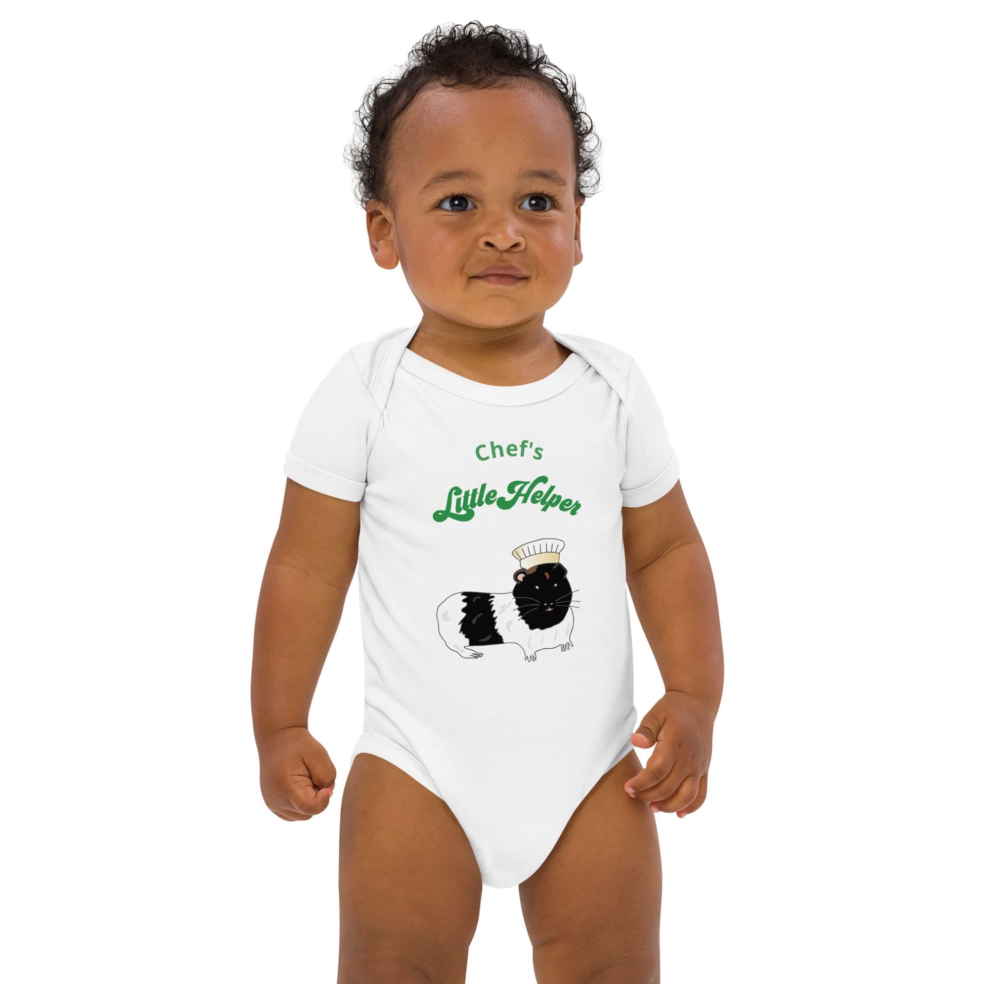 White baby bodysuit featuring a hand-painted guinea pig in a chef’s hat with playful green text 'Chef's Little Helper'.