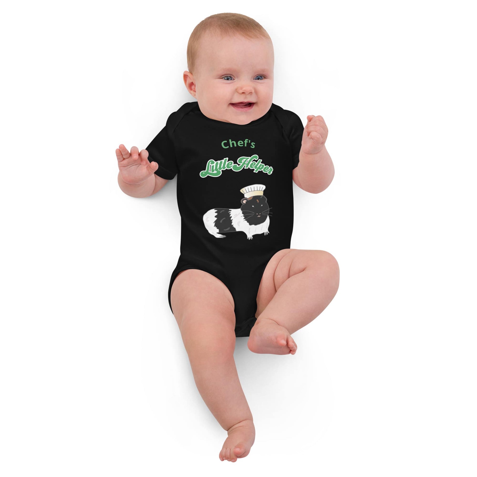 Baby Girl wearing organic bodysuit in black with a guinea pig chef illustration and green "Chef’s Little Helper" text.