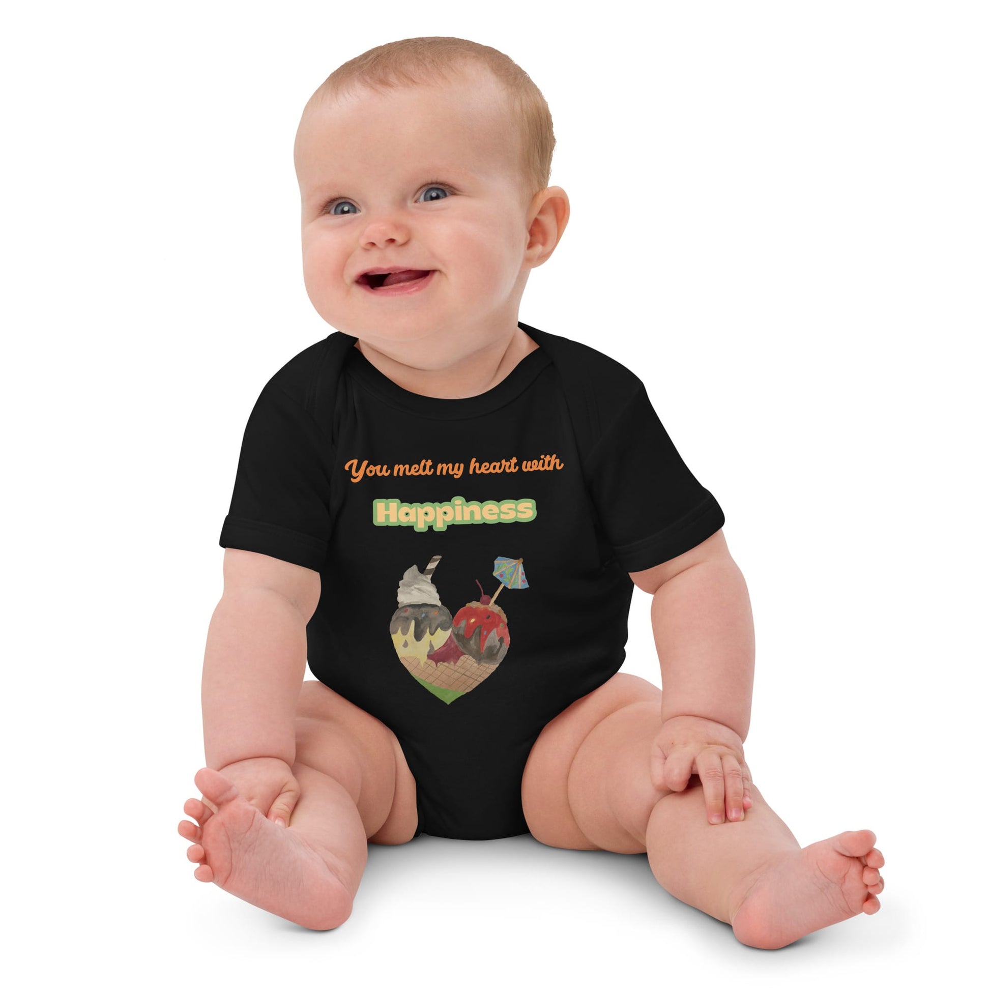 Smiling baby girl wearing black organic bodysuit with ice cream heart graphic and the words 'You melt my heart with Happiness'.