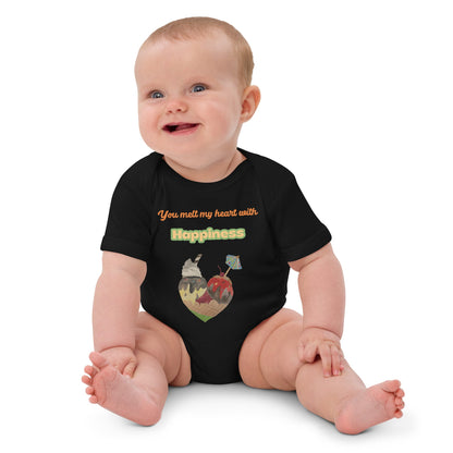 Smiling baby girl wearing black organic bodysuit with ice cream heart graphic and the words 'You melt my heart with Happiness'.