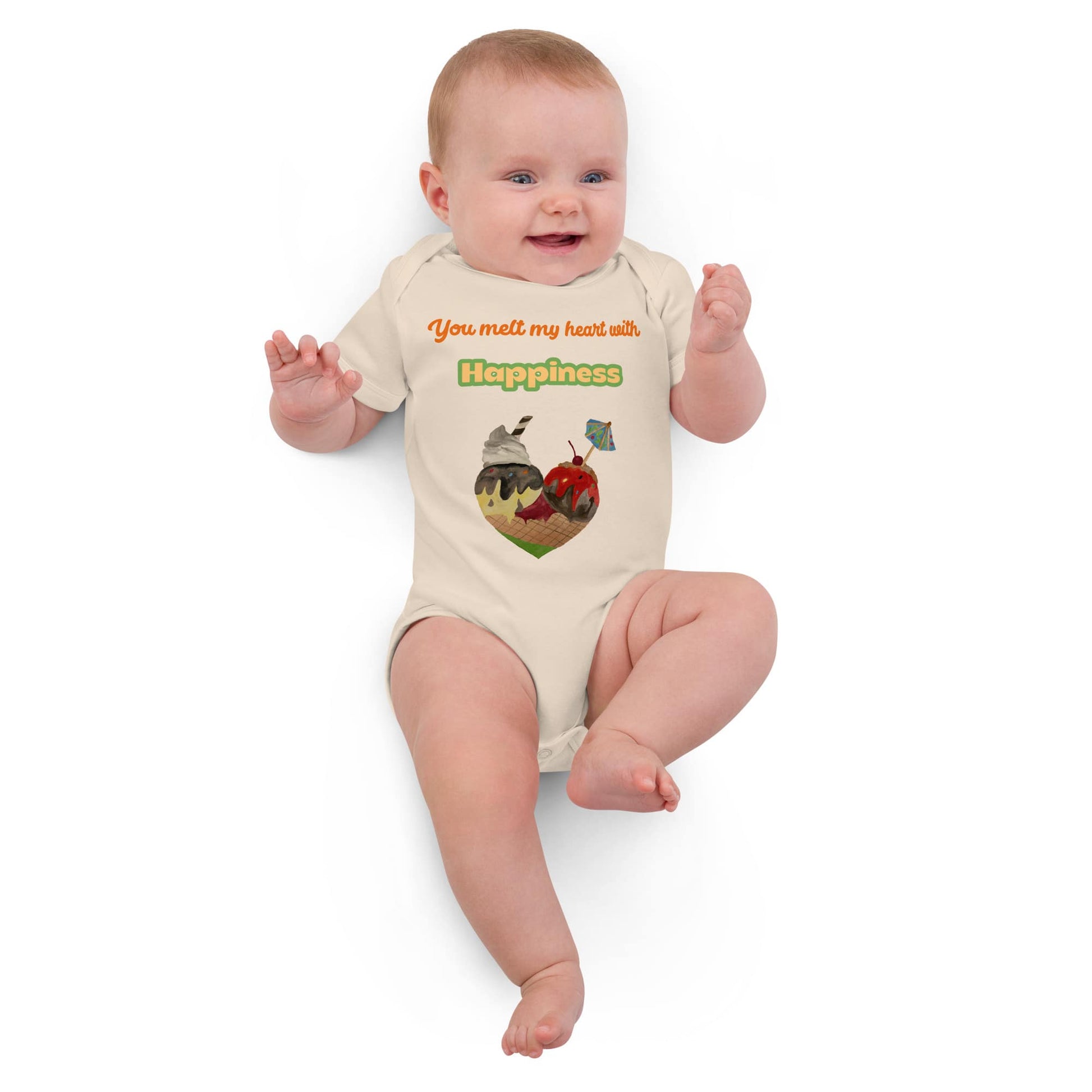 Smiling baby girl wearing natural-color organic bodysuit with ice cream heart graphic and the words 'You melt my heart with Happiness'.