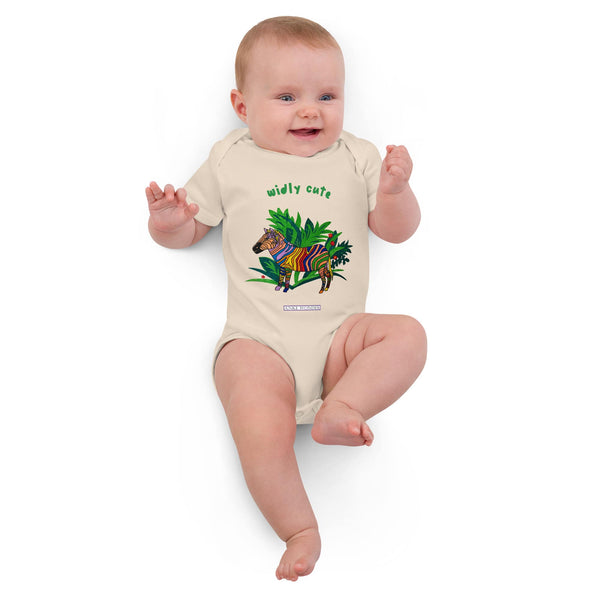 Baby Girl wearing a onesie with a zebra and palm tree design on a white background