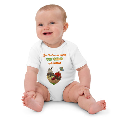 Smiling baby girl wearing white organic bodysuit with colorful German quote and ice cream cone heart.