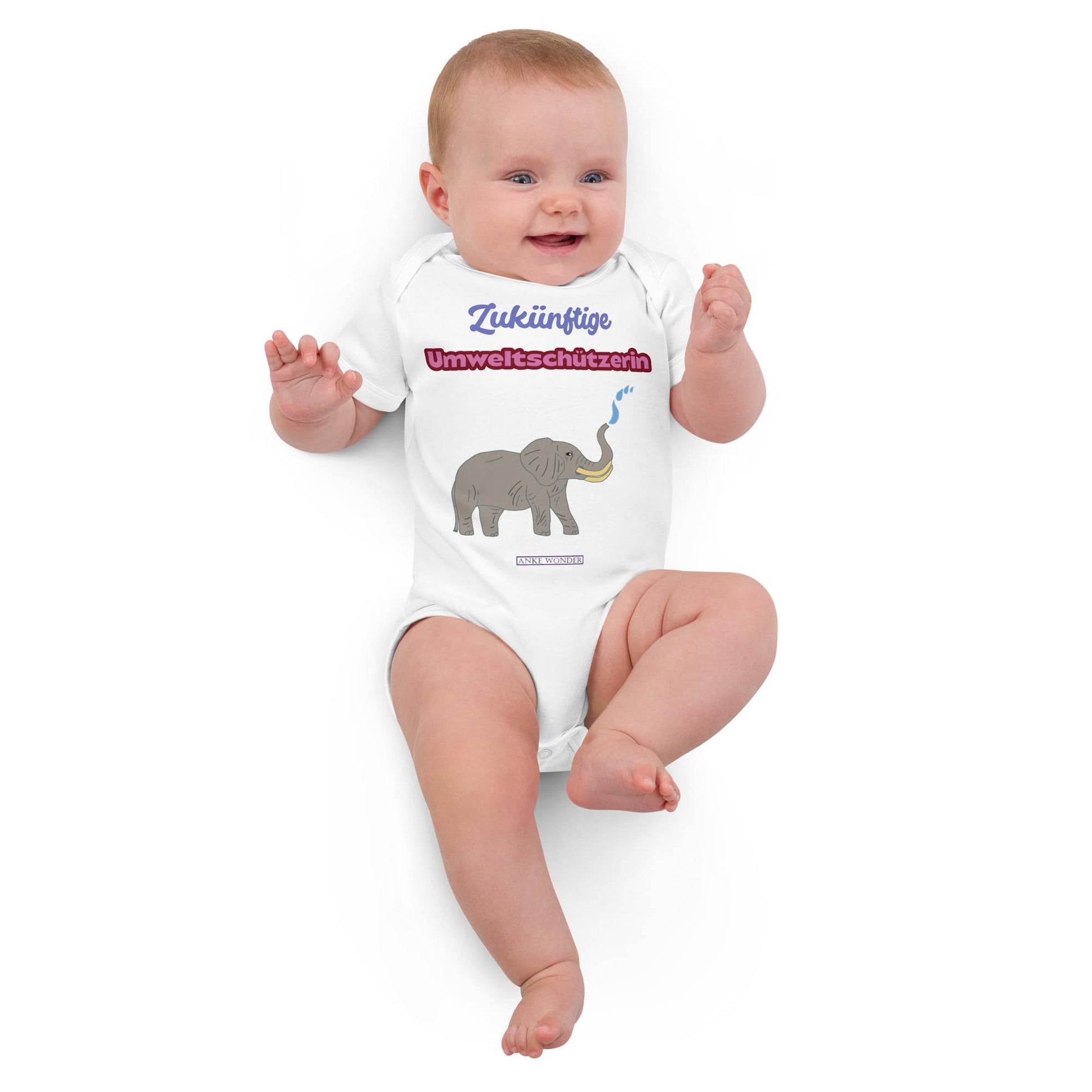 Baby wearing a white onesie with an elephant graphic and with German slogan “Zukünftige Umweltschützerin” on a white background