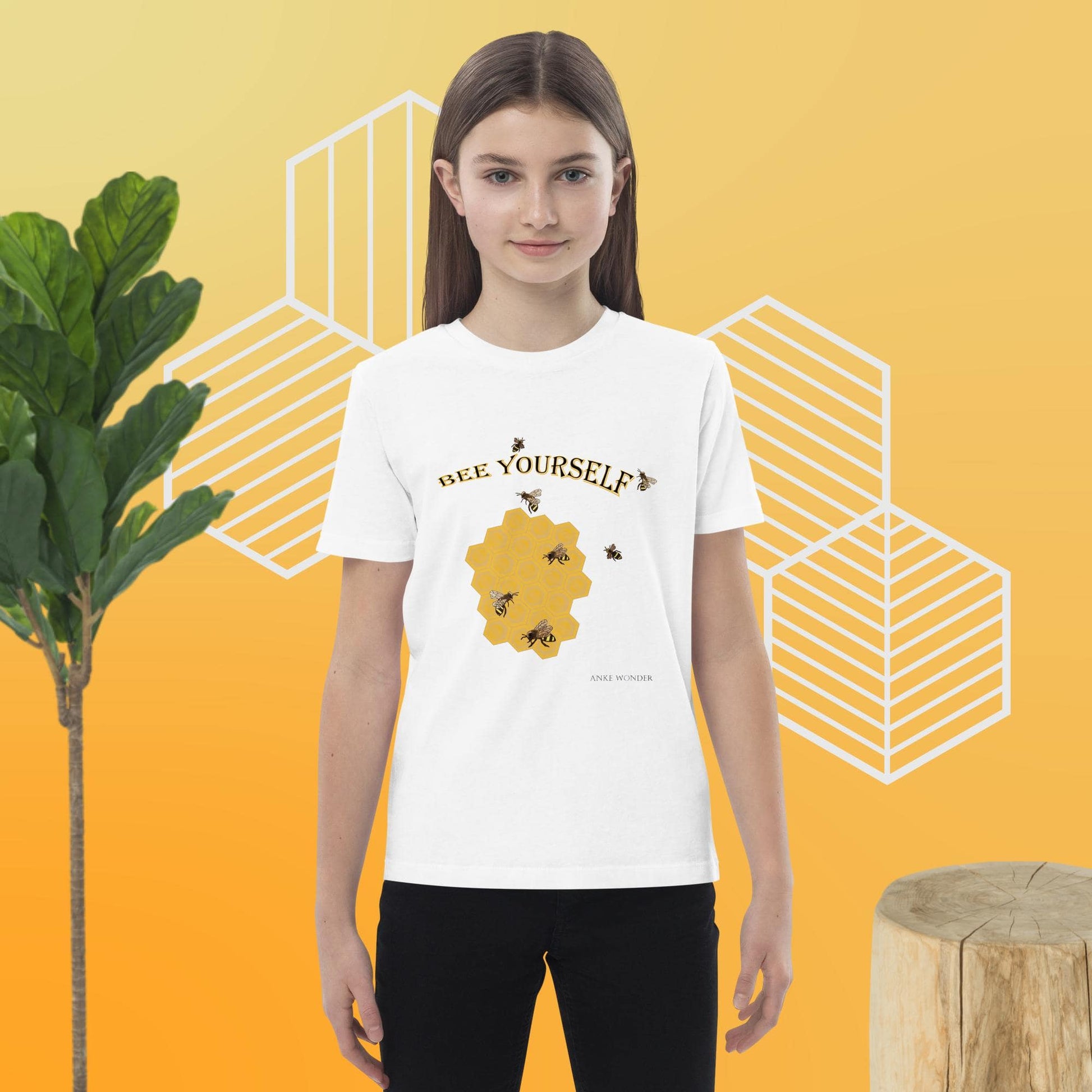 Girl wearing a white t-shirt with 'BEE YOURSELF' and a honeycomb design on a yellow background