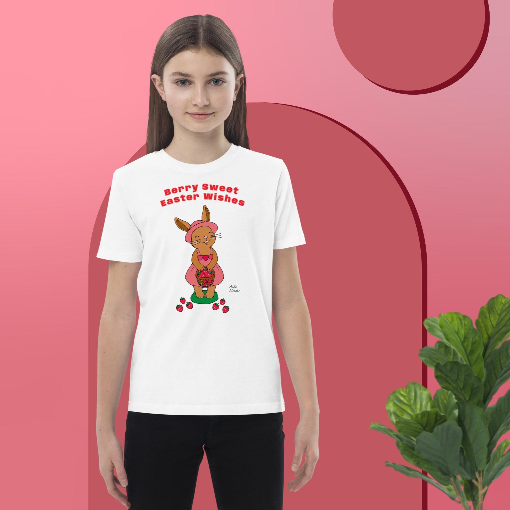 Girl wearing a white t-shirt with an Easter bunny design on a pink background