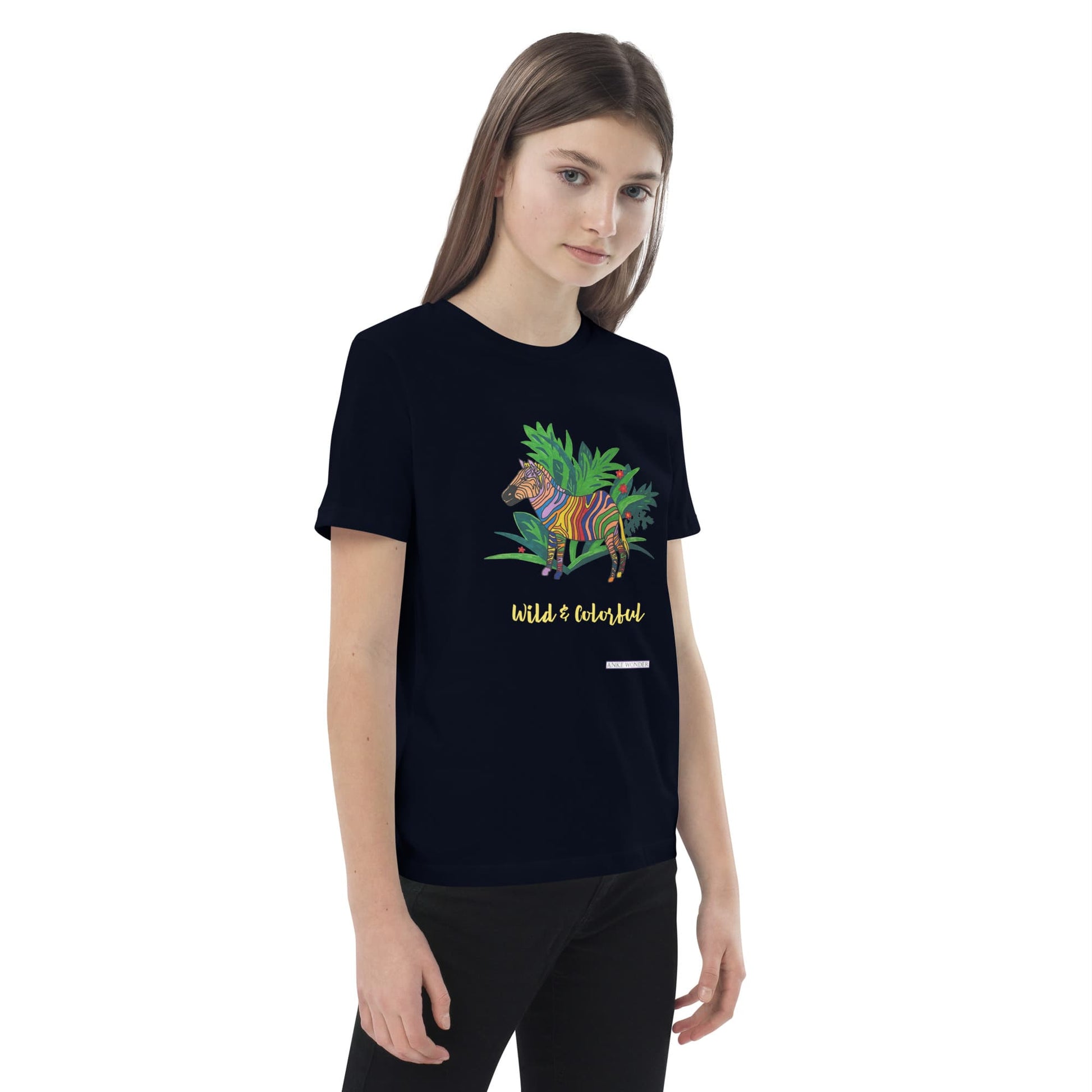 Young girl wearing a navy t-shirt with a colorful zebra design and text 'Wild & Colorful' on a white background