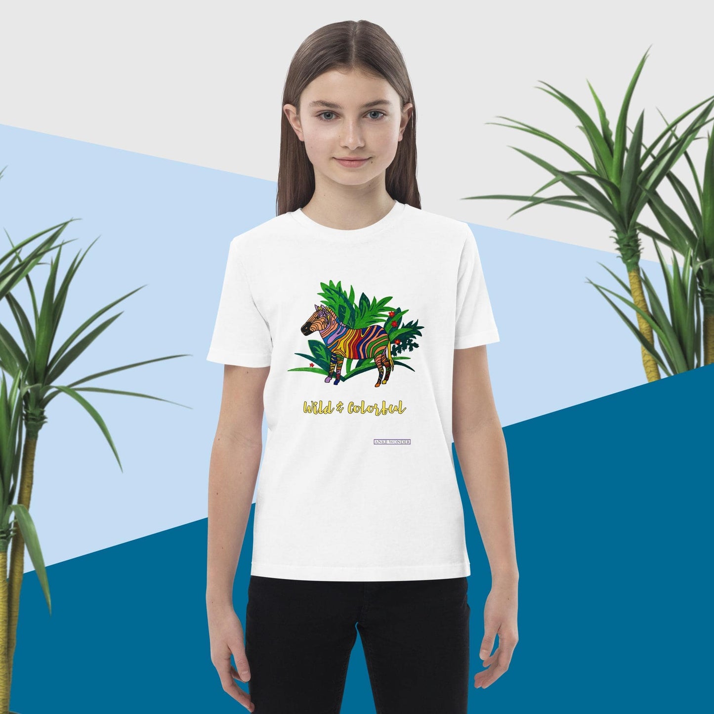 Girl wearing a white t-shirt with a zebra design and text 'Wild & Colorful', standing against a blue and green abstract background.