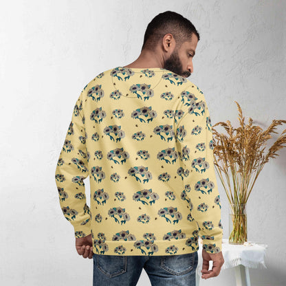 Back view of man wearing a yellow floral-patterned sunflower and bee sweatshirt in a minimalistic setting.