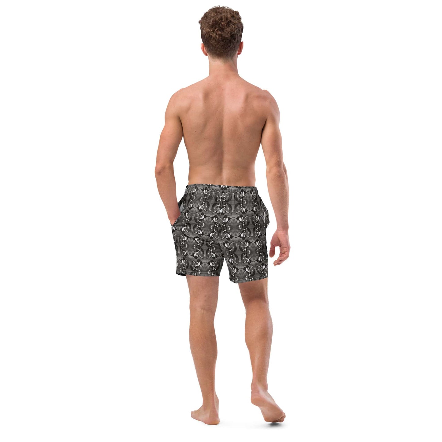 Back view of men’s black and white swim trunks made from recycled polyester. Displays mirrored bird pattern and sustainable swimwear fit.
