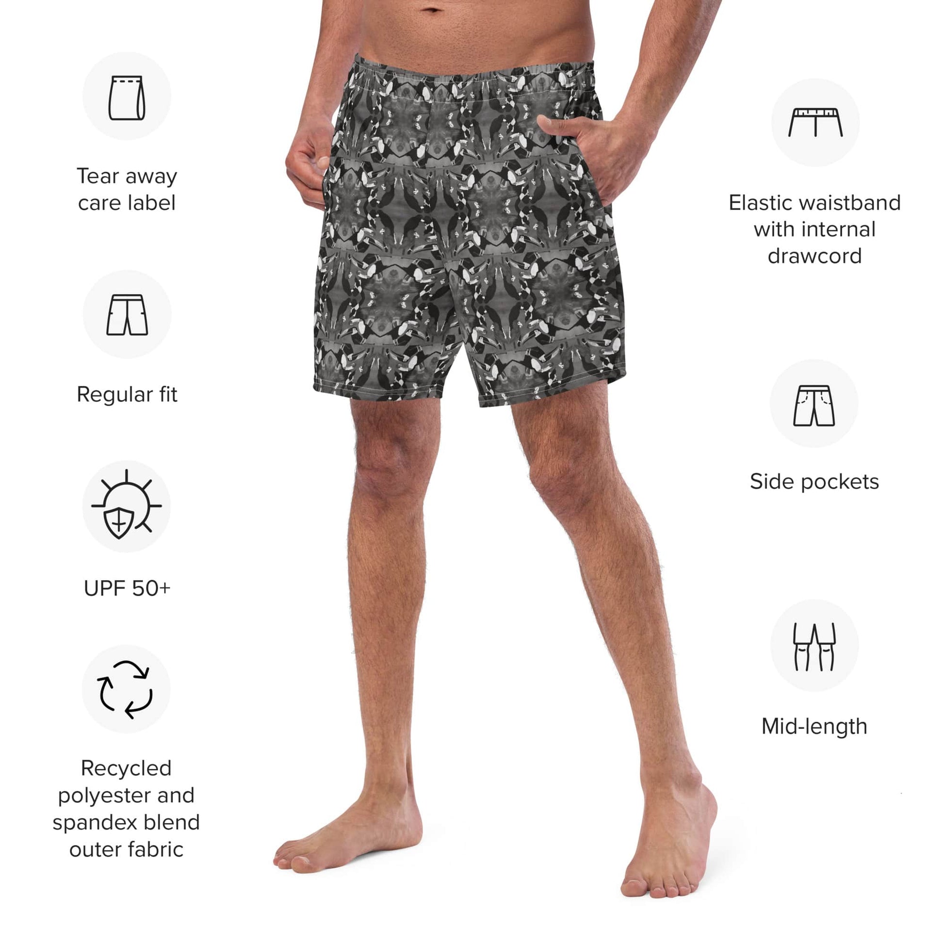 Close-up of the front-left view of men’s recycled swim trunks with a black and white mirrored bird pattern. Eco-friendly swimwear featuring elastic waistband and side pocket.