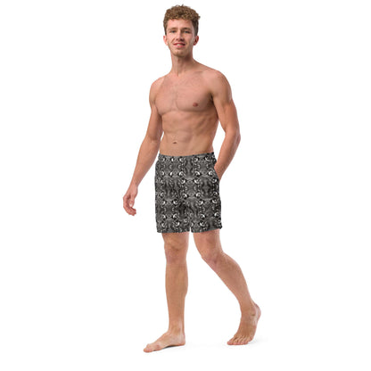 Left side view of men’s swim trunks featuring a mirrored bird art pattern. Recycled fabric, side pocket, and elastic waistband visible.