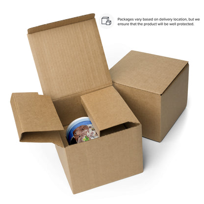 Open cardboard box with a colorful mug inside on a white background