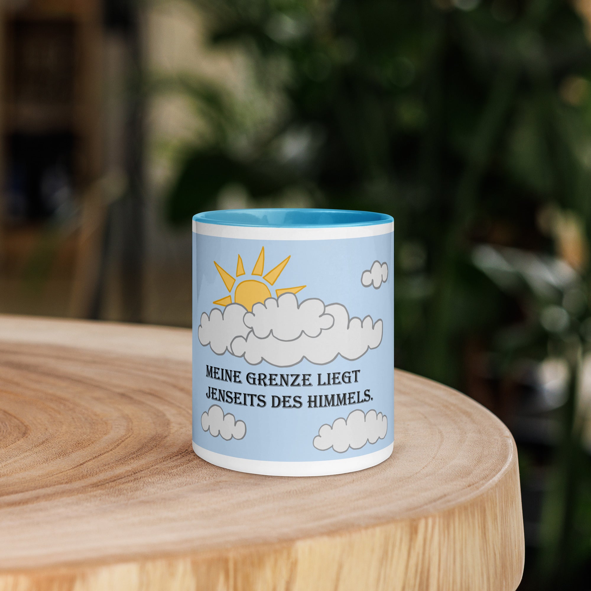 Front view of the 'Meine Grenze liegt jenseits des Himmels' 15oz blue ceramic mug, designed by Anke Wonder with a motivational message in German.