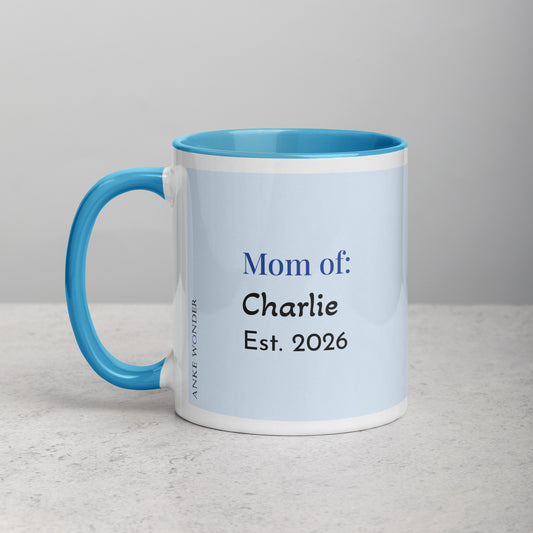 Backside of white and blue ceramic mug with a rblue handle and red interior displaying the words "Guinea Pig Mom" and an illustrated black and white guinea pig.