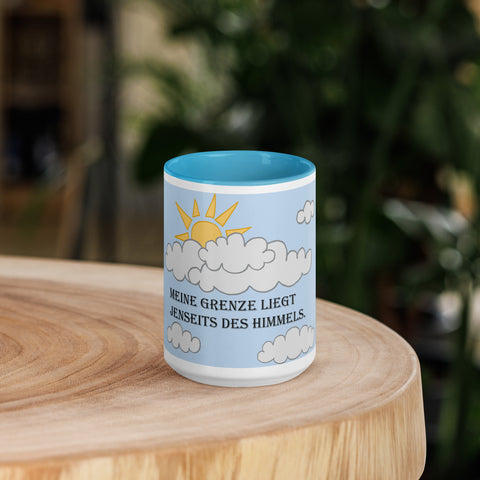 Front view of the 'Meine Grenze liegt jenseits des Himmels' 11oz blue ceramic mug, featuring a motivational German phrase and blue accents.