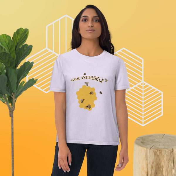 Woman wearing a white t-shirt with a bee-themed design with the words 'Bee Yourself' on a yellow background