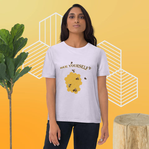 Woman wearing a white t-shirt with a bee-themed design with the words 'Bee Yourself' on a yellow background