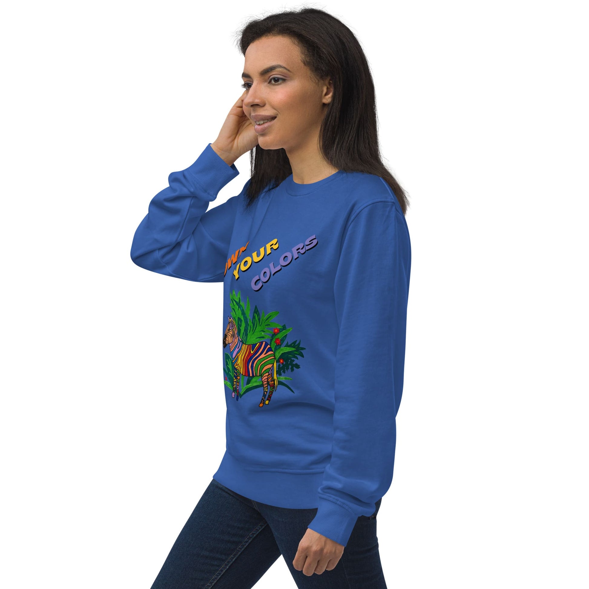 Side view of woman wearing a blue sweatshirt with colorful zebra graphics and text on a white background