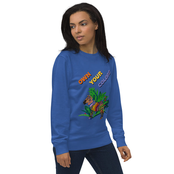 Woman wearing a blue sweatshirt with colorful zebra graphics and text on a white background