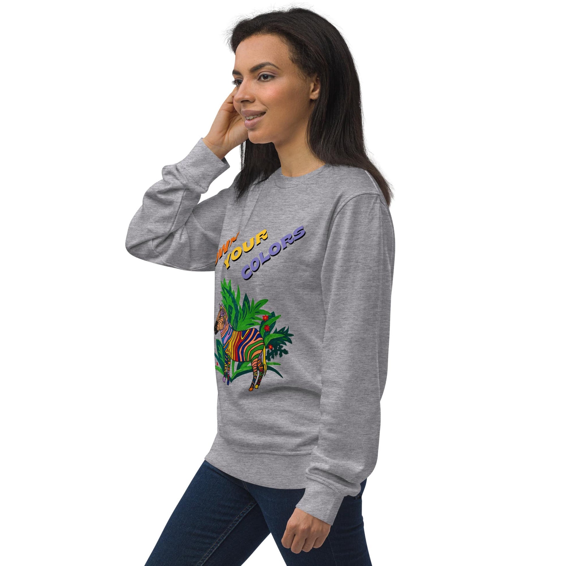 Side view of woman wearing a gray sweatshirt with colorful zebra design and text on a white background