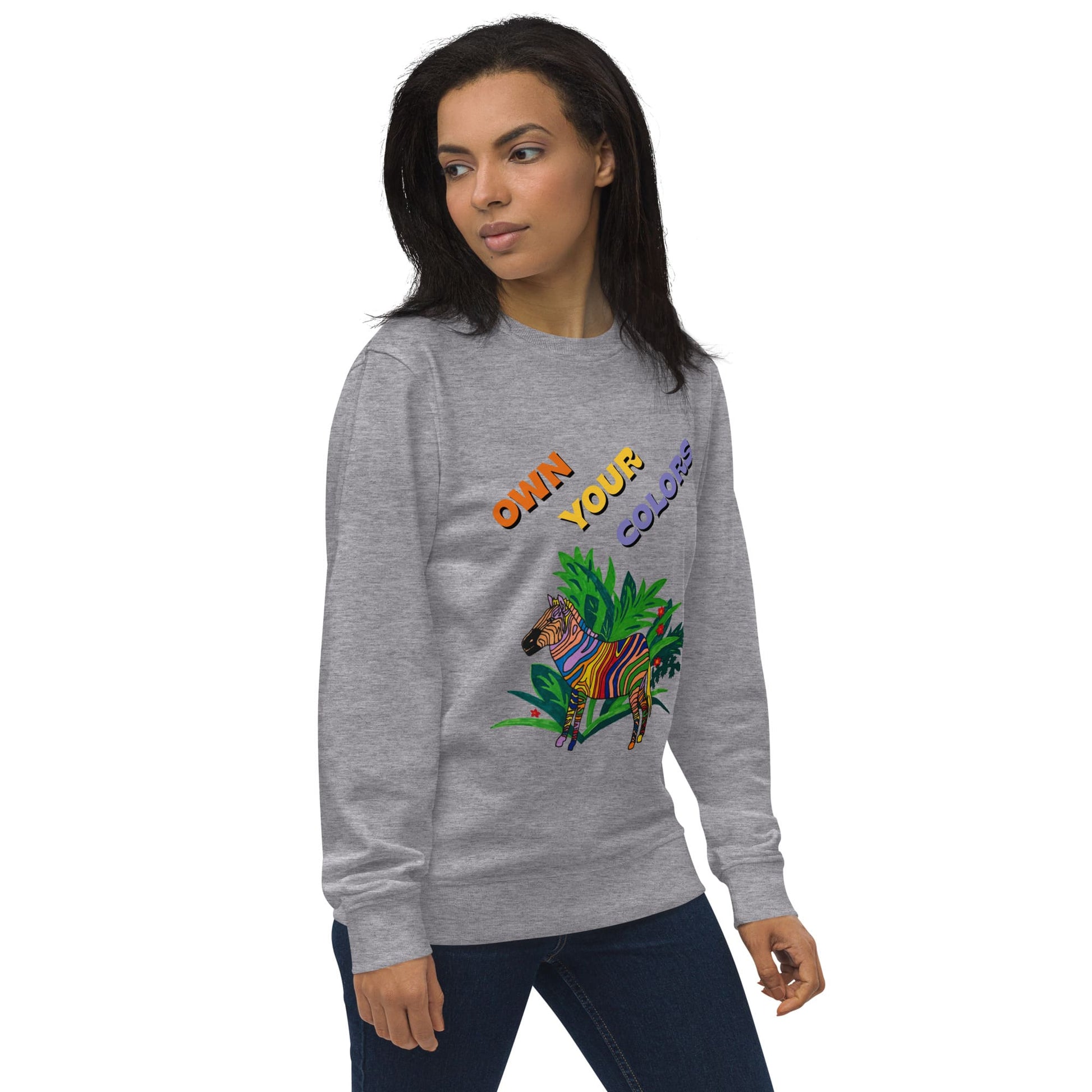 Woman wearing a gray sweatshirt with colorful zebra graphics and text on a white background