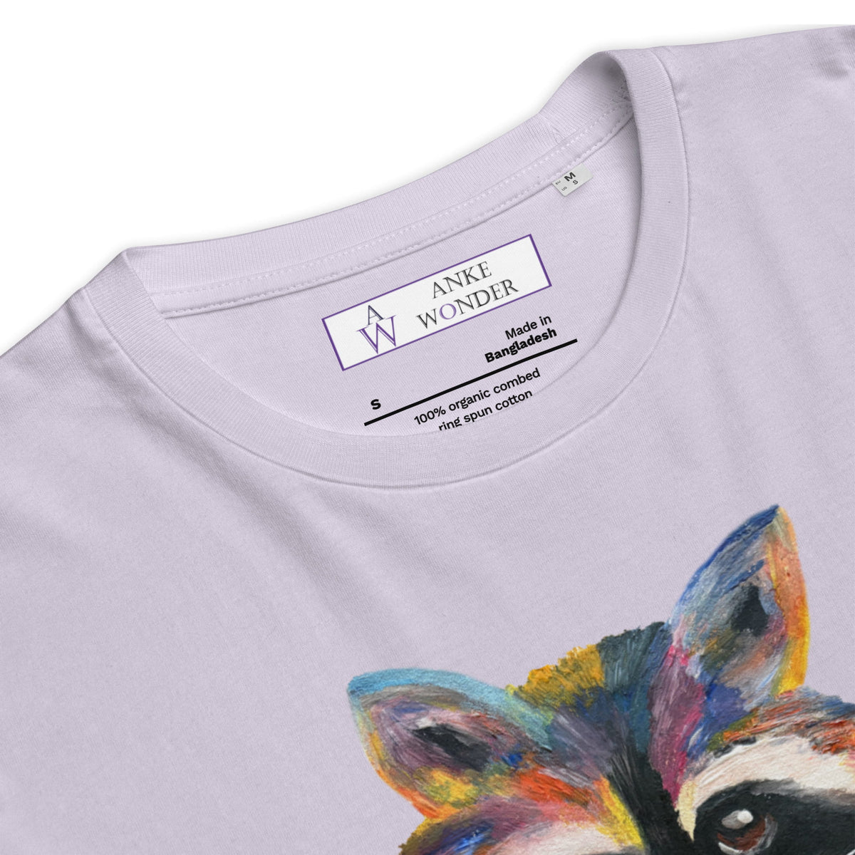 Close-up of a light lavender crewneck t-shirt featuring a colorful painted fox graphic on the front. The inside collar shows the brand label 'Anke Wonder'.