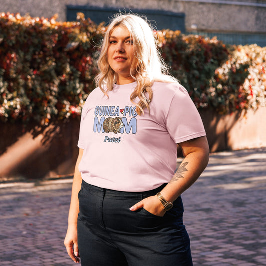 Person wearing a pink t-shirt with 'GUINEA PIG MOM' text, standing outdoors.