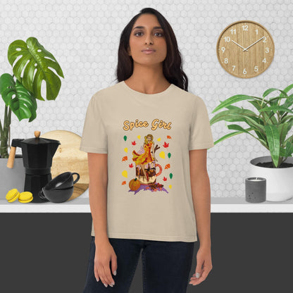 Woman wearing a beige t-shirtwith a pumpkin spice latte design and the text 'Spice Girl' in a kitchen setting