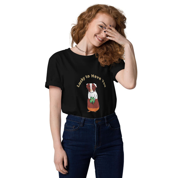 Woman wearing a black organic cotton t-shirt tucked into jeans, showcasing a guinea pig holding a shamrock with "Lucky to Have You" text above.