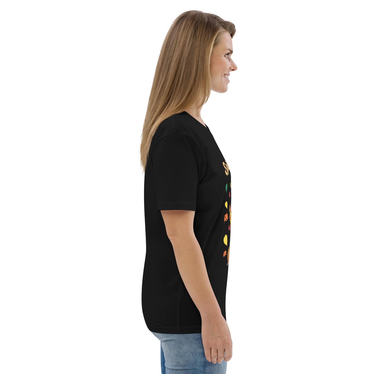 Side view of woman wearing a black t-shirt with colorful graphics on a white background