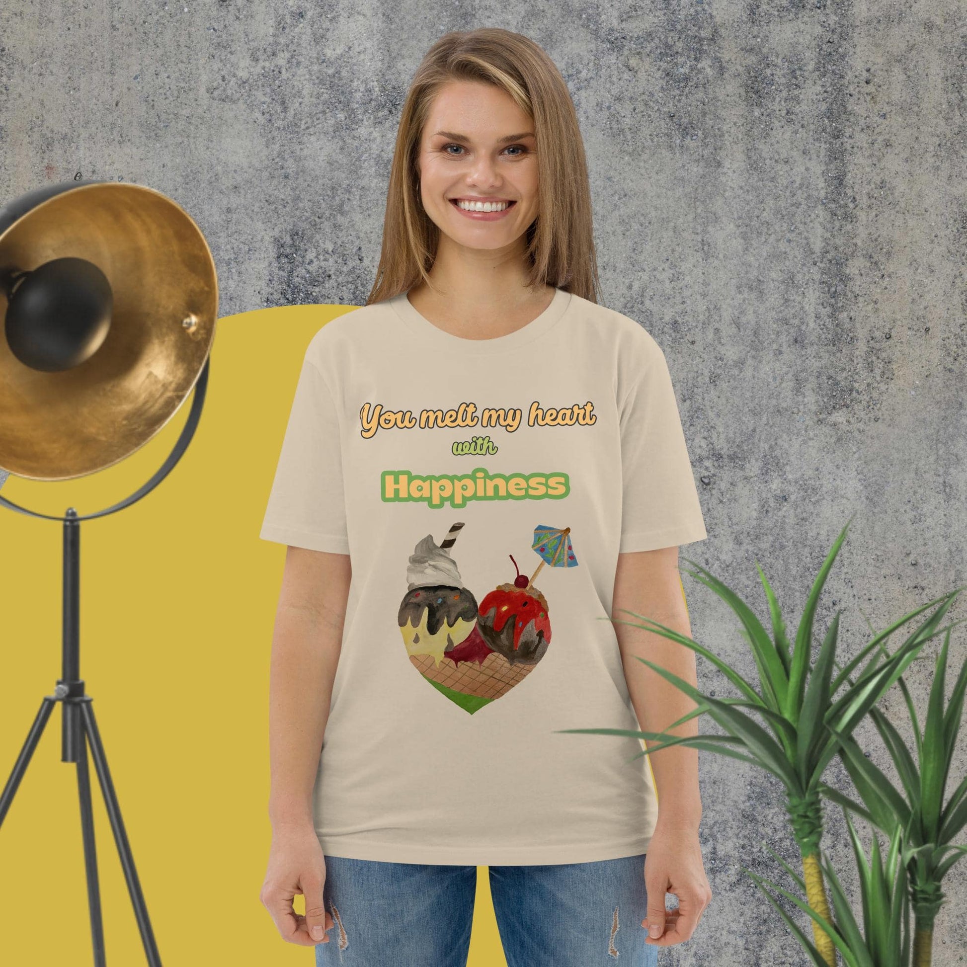 Woman wearing desert dust organic cotton t-shirt with colorful ice cream heart design and the phrase “You melt my heart with Happiness” by Anke Wonder.