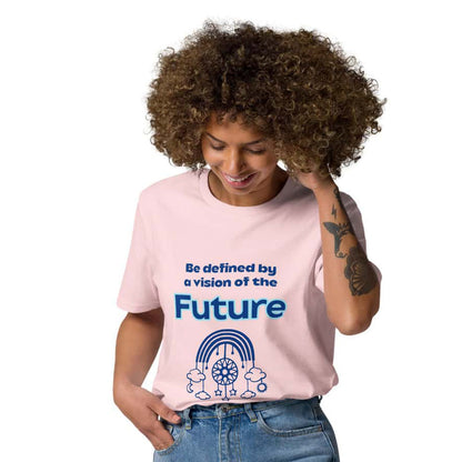 A Black woman wearing a pink organic cotton t-shirt tucked into high-waisted blue jeans, standing confidently. The t-shirt features a light blue futuristic dream catcher design and inspiring quote 'Be definied by a vision of the future'.