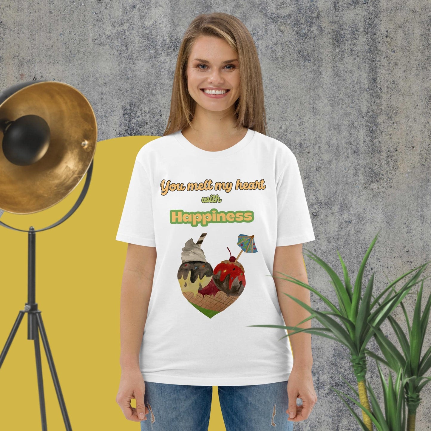Woman wearing white organic cotton t-shirt with colorful ice cream heart design and the phrase “You melt my heart with Happiness” by Anke Wonder.