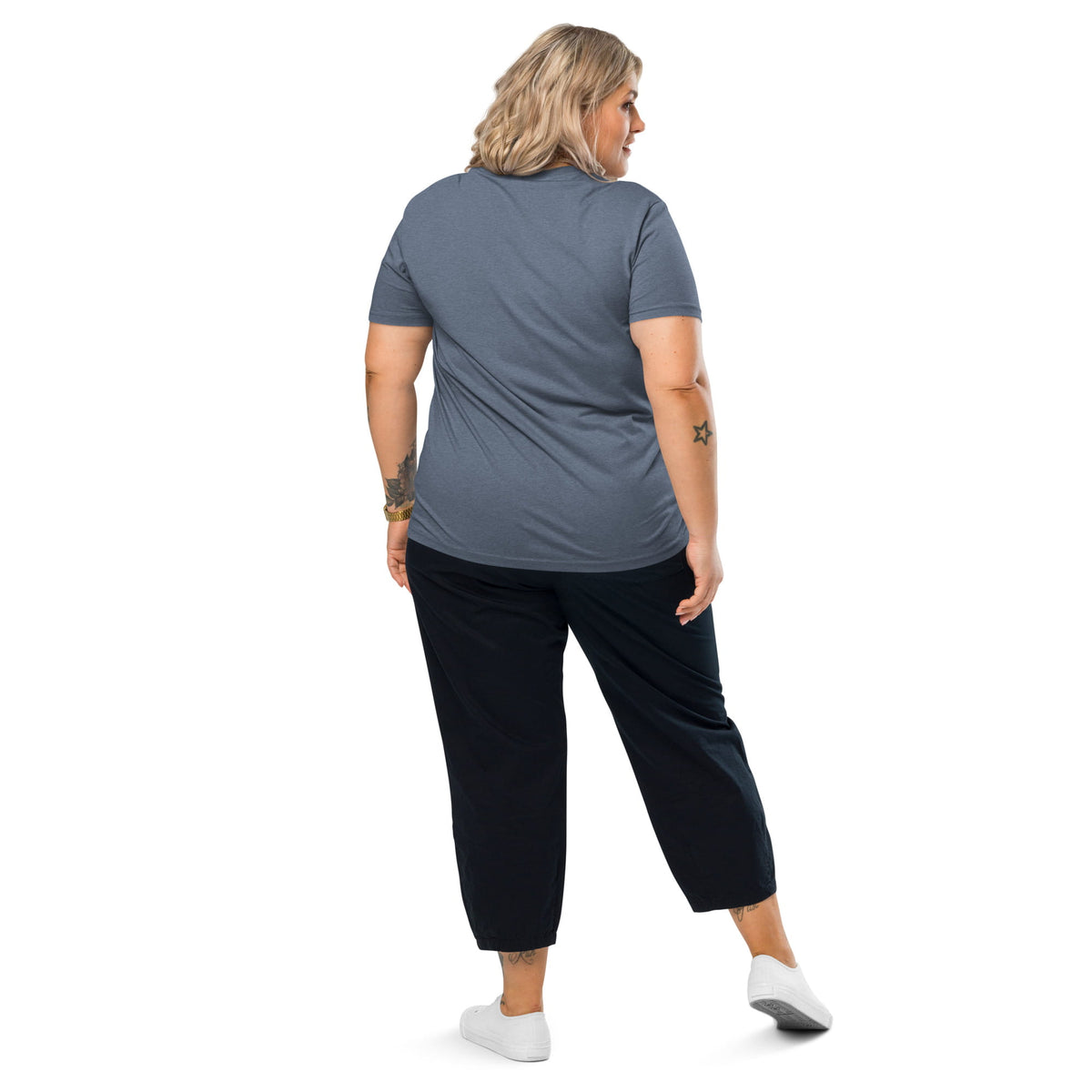 Woman wearing a gray t-shirt and black pants on a white background