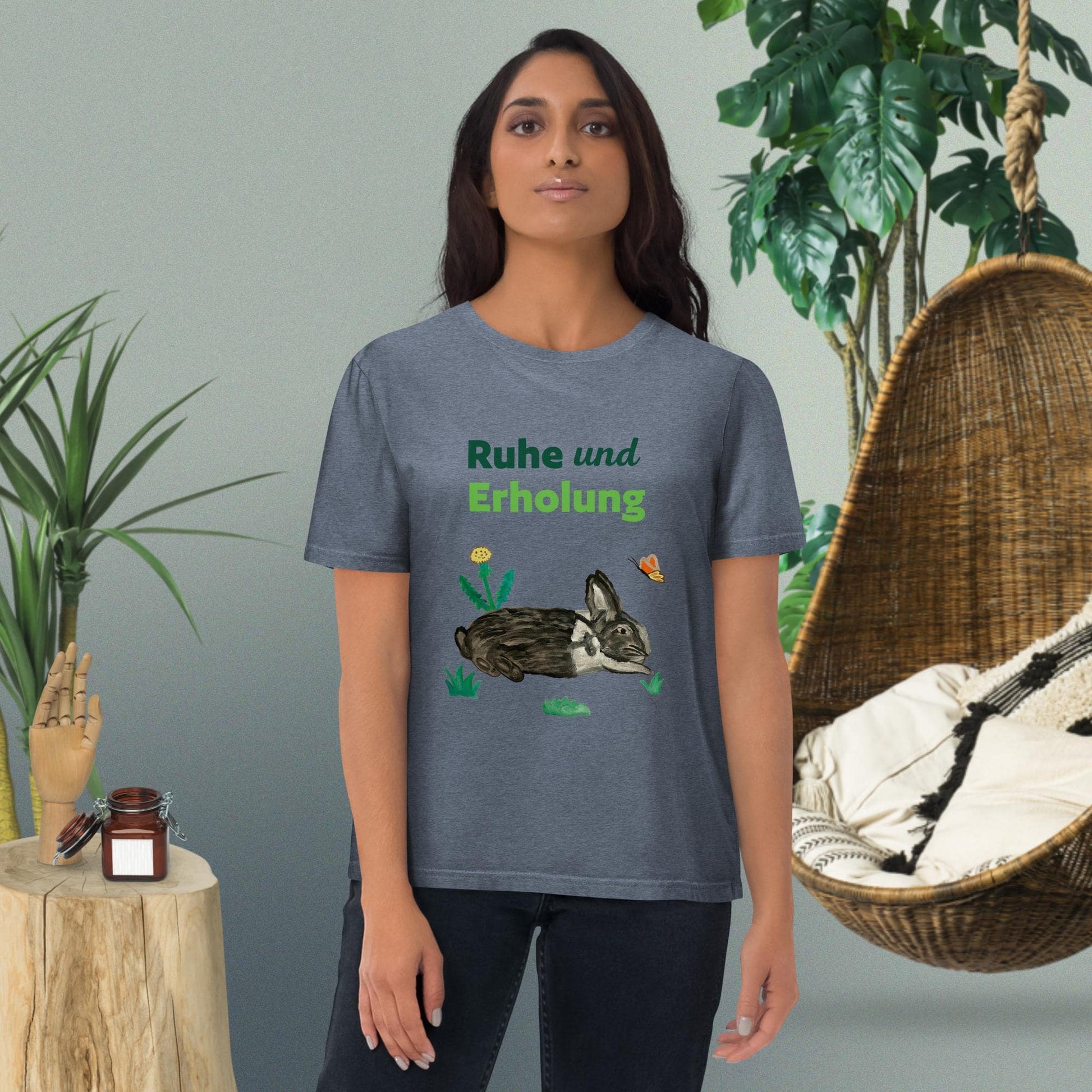 Woman wearing "Ruhe & Erholung" t-shirt in dark heather blue, with rabbit and butterfly design by Anke Wonder.