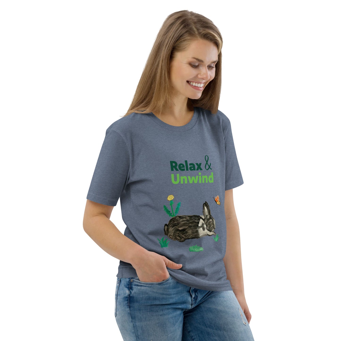 Woman wearing dark heather blue organic cotton t-shirt with Relax & Unwind design — hand-painted rabbit, butterfly, and greens — front view, right angle.