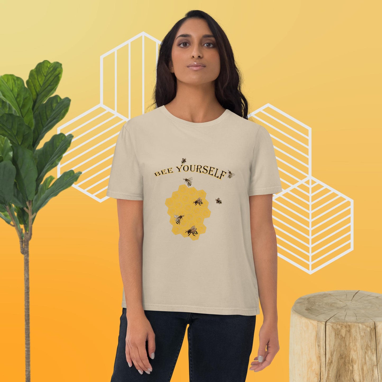 Woman wearing a 'Be Yourself' t-shirt with bee graphics on a yellow background
