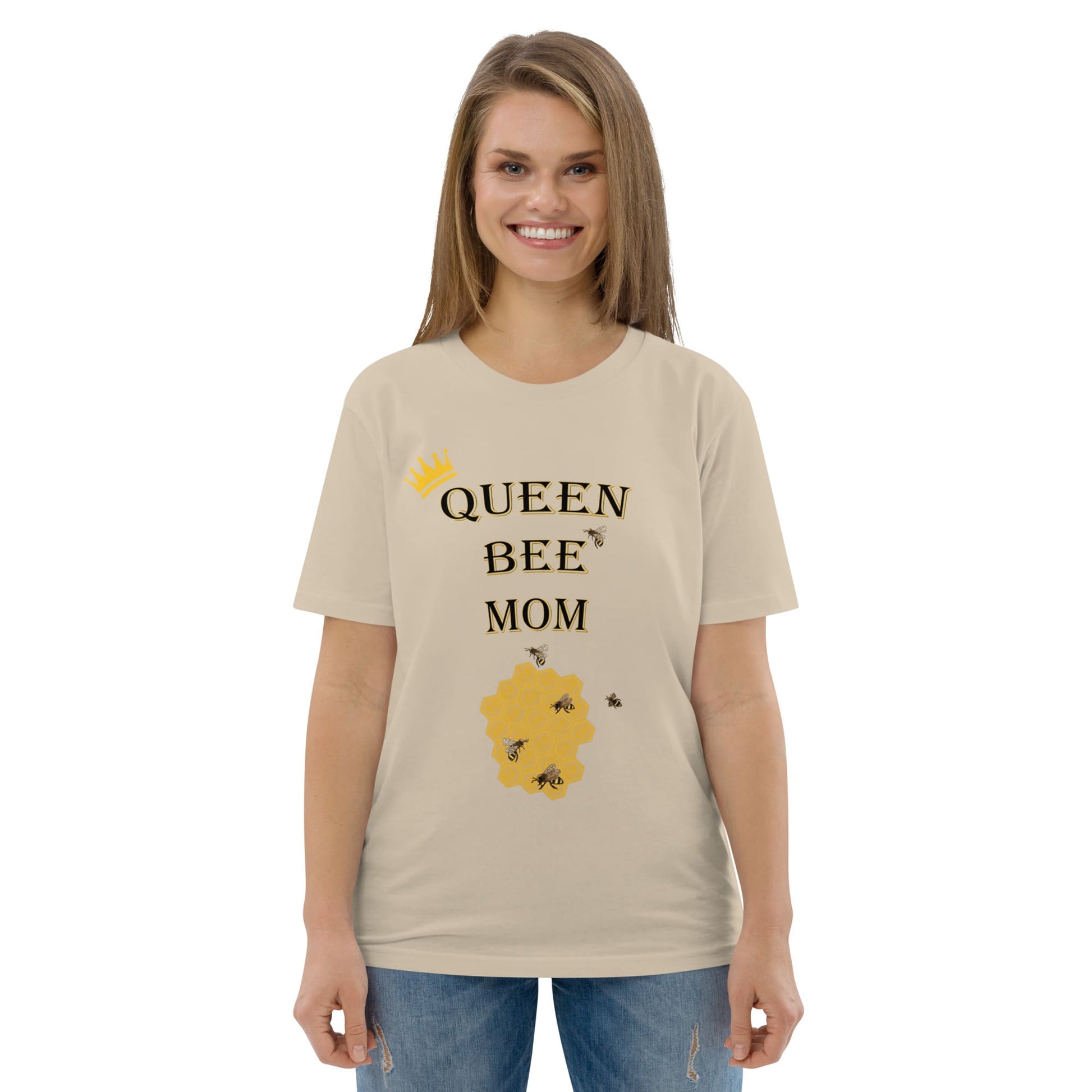 Woman wearing desert dust Queen Bee Mom organic cotton t-shirt, smiling, front view.