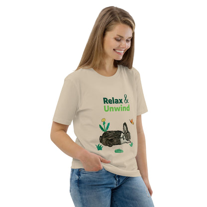 Woman wearing desert dust organic cotton t-shirt with Relax & Unwind design — hand-painted rabbit, butterfly, and greens — front view, right angle.